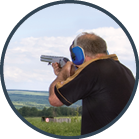 A man shoots a gun on skeet